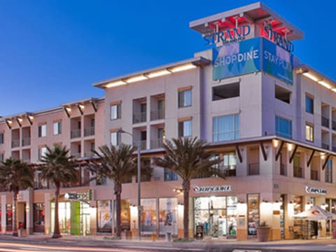 A building with palm trees in front of it.