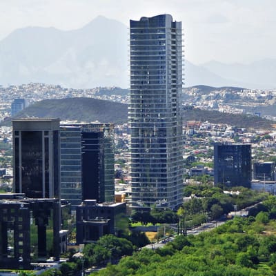 A view of the city from above shows tall buildings.