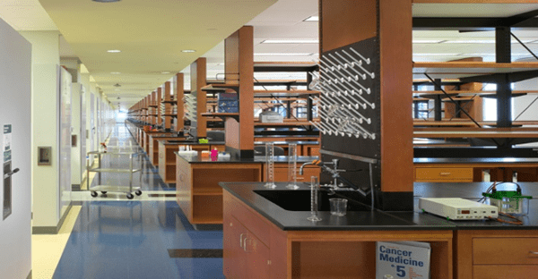 A sink in a hall with glass funnels used for chemistry kept nearby.